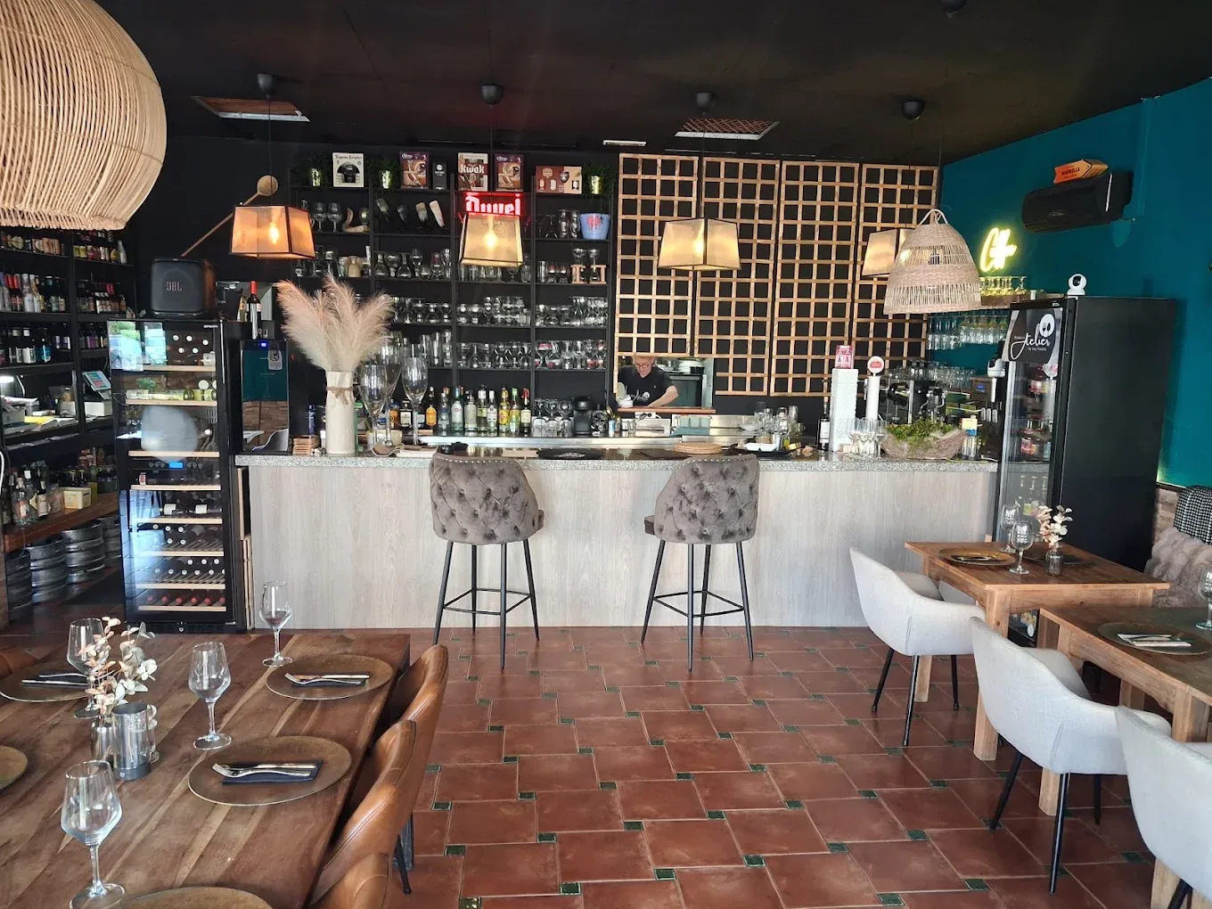 The Brasserie Atelier dining room with turquoise walls, timber tables and woven pendant lighting